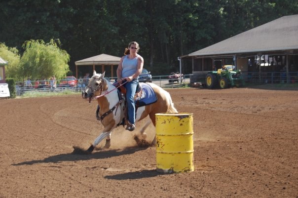 A horse running around a barrel